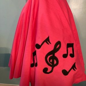 Homemade 1950s circle skirt in bright pink with treble clef and musical notes